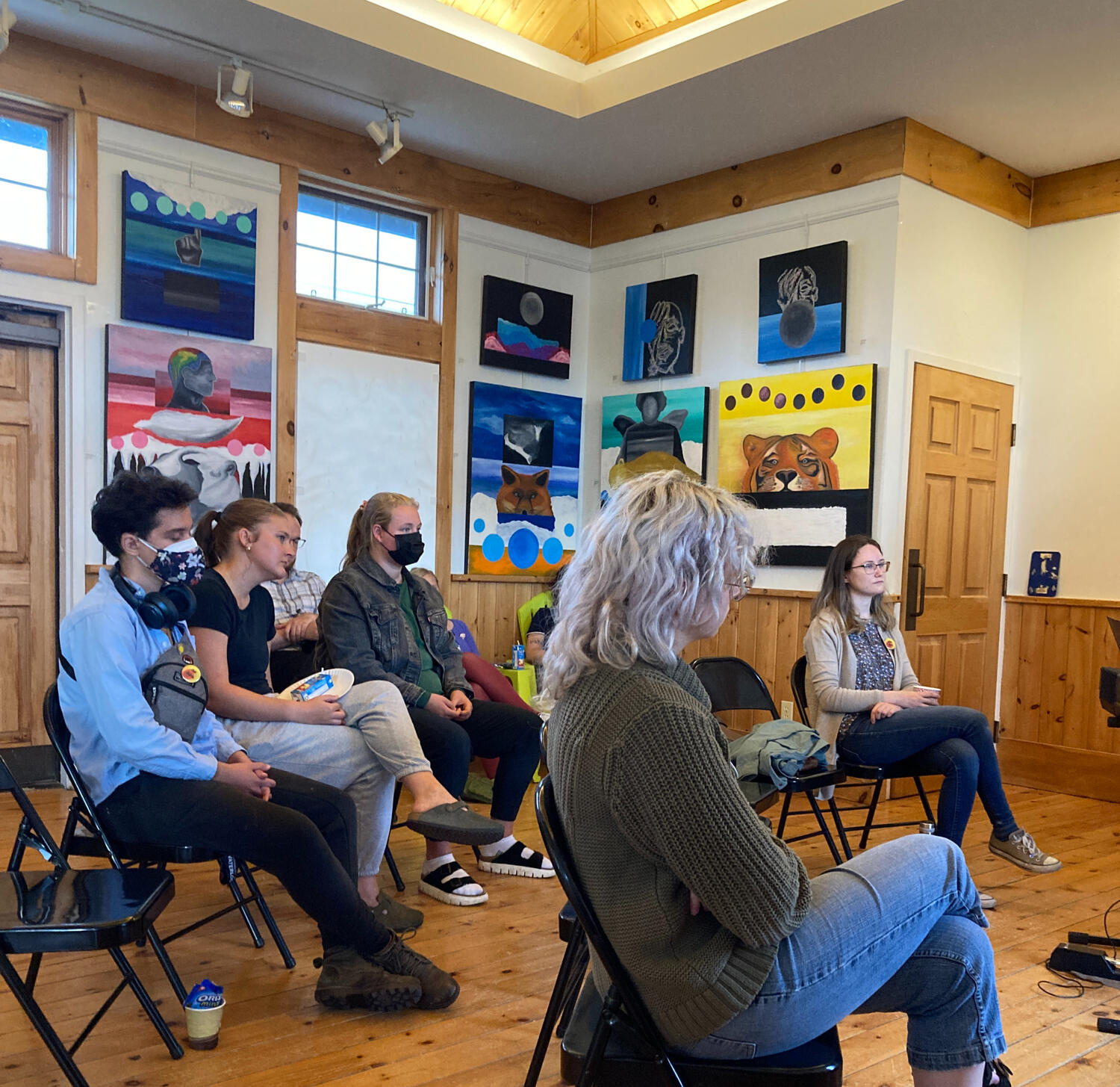 Audience members listening to performances